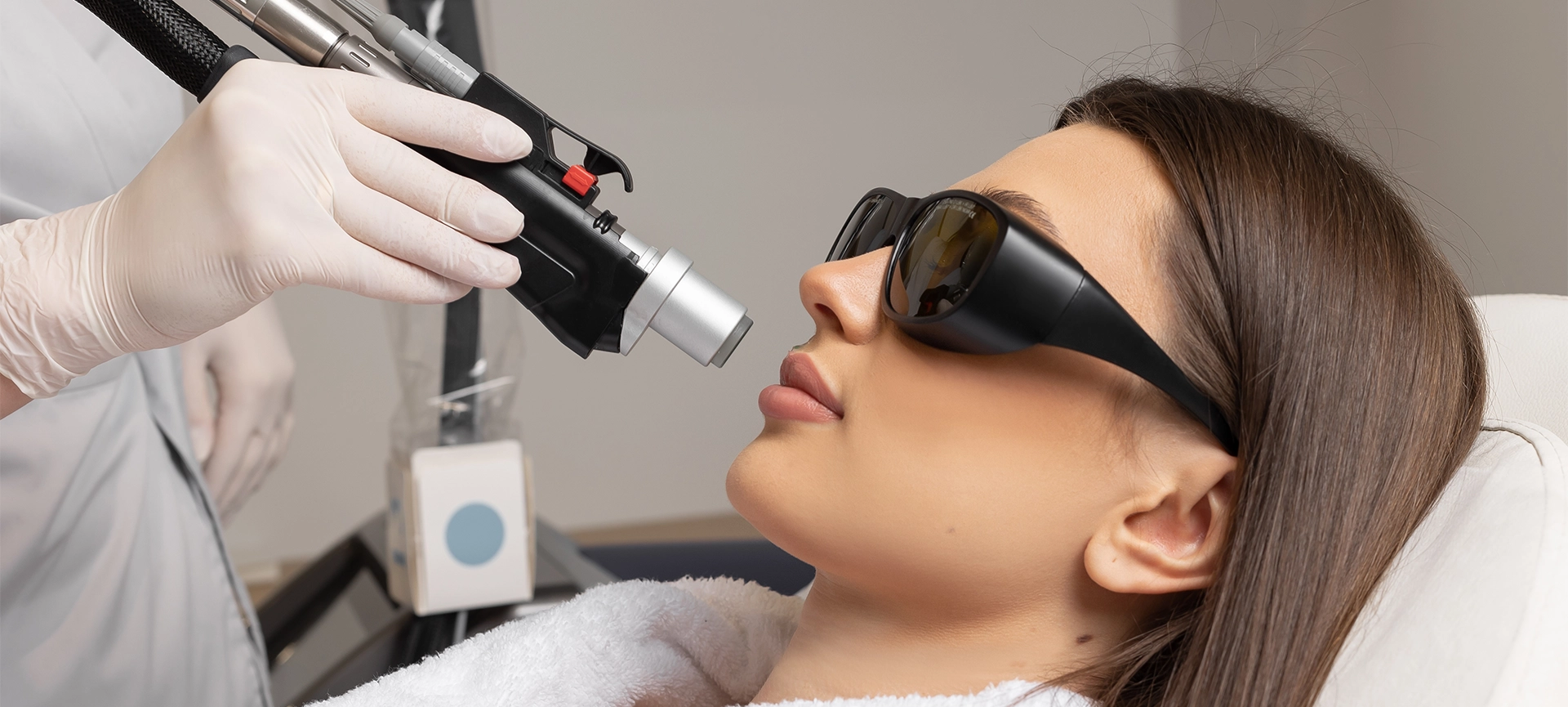 cosmetologist make laser hair removal on woman's under nose
